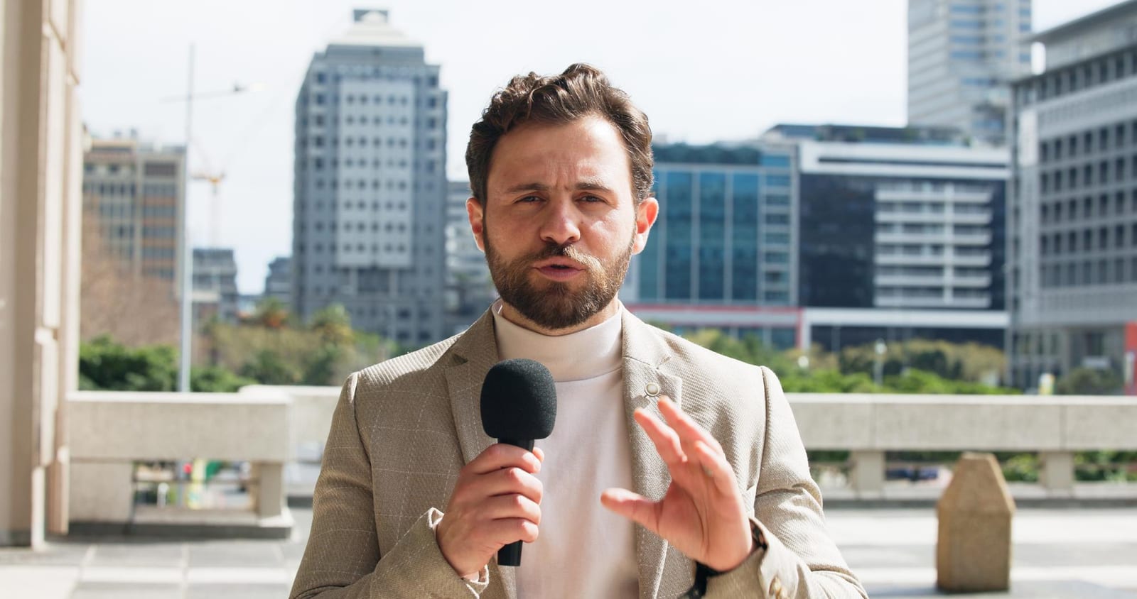 A Fiddlehead Press reporter recording an on-location segment near the lakeshore.