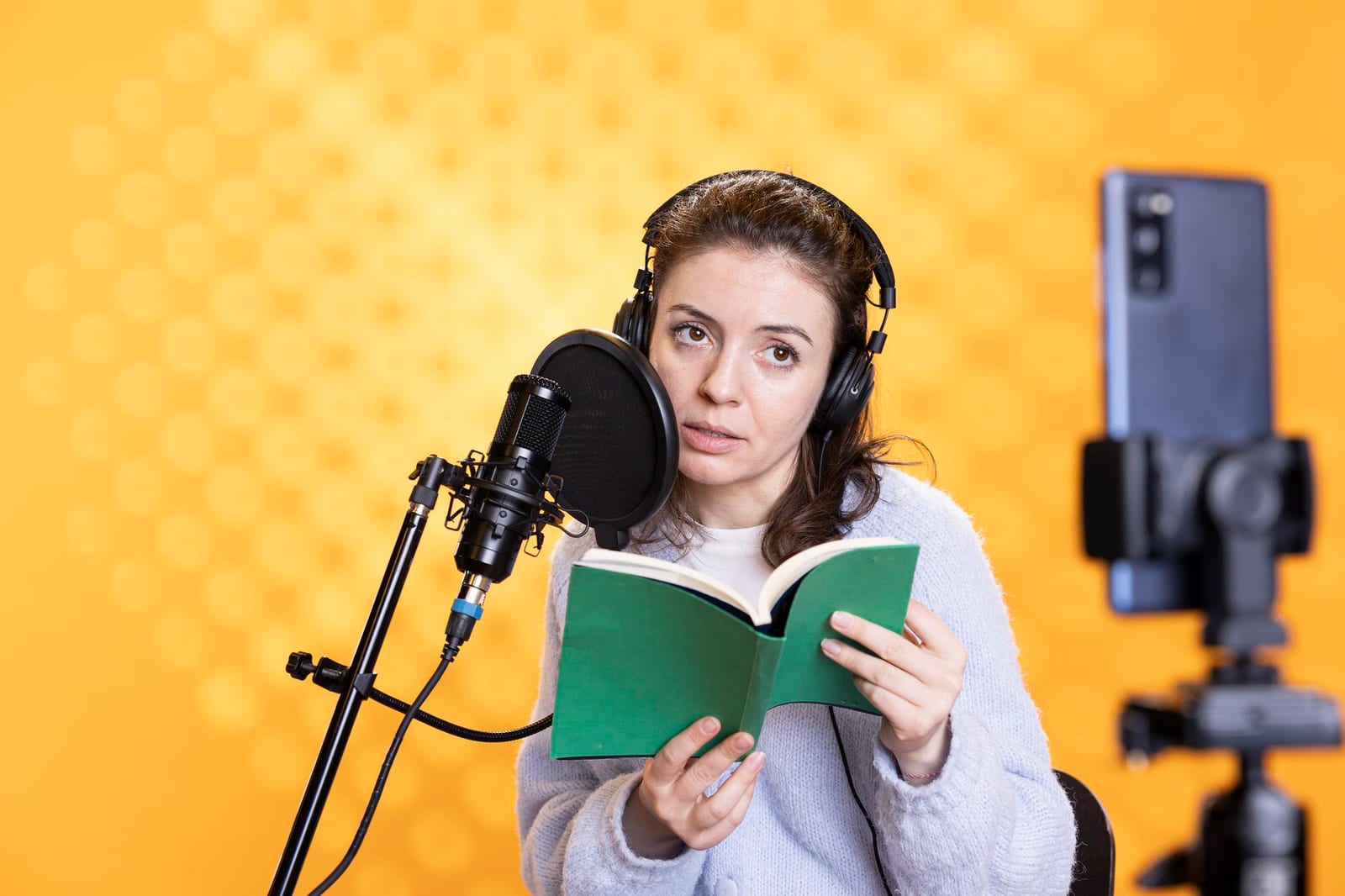 A Fiddlehead Press team member recording narration while reading from a script.