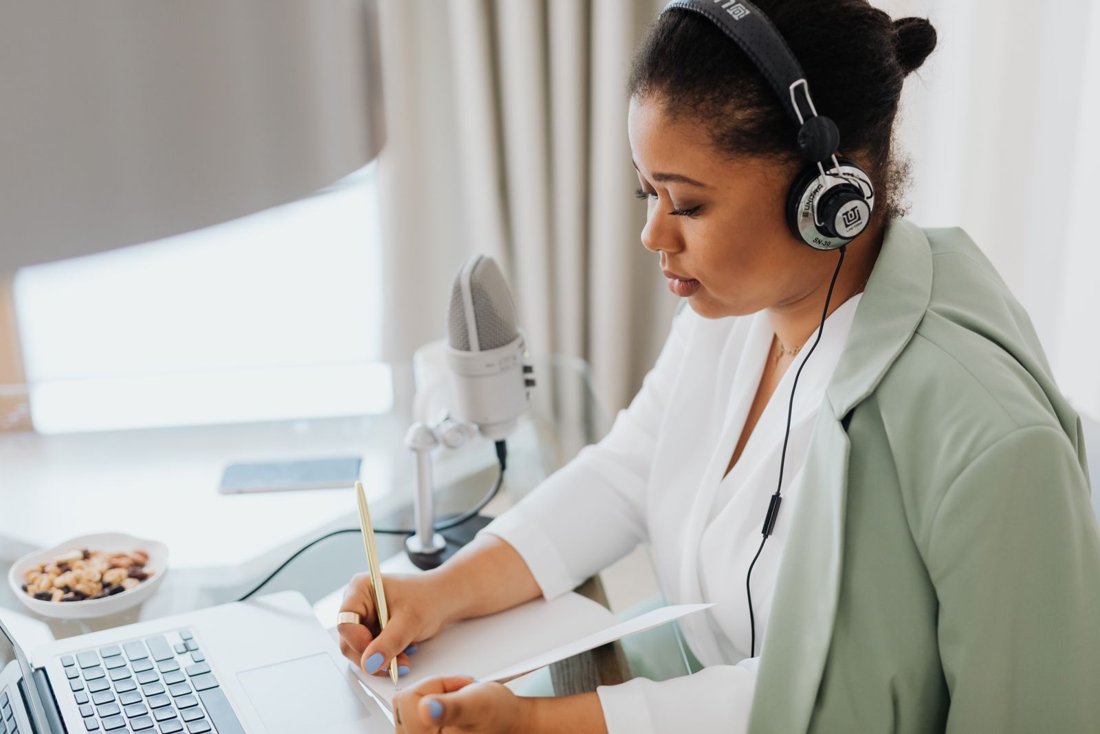 A podcast host recording a segment for a Fiddlehead Press episode.
